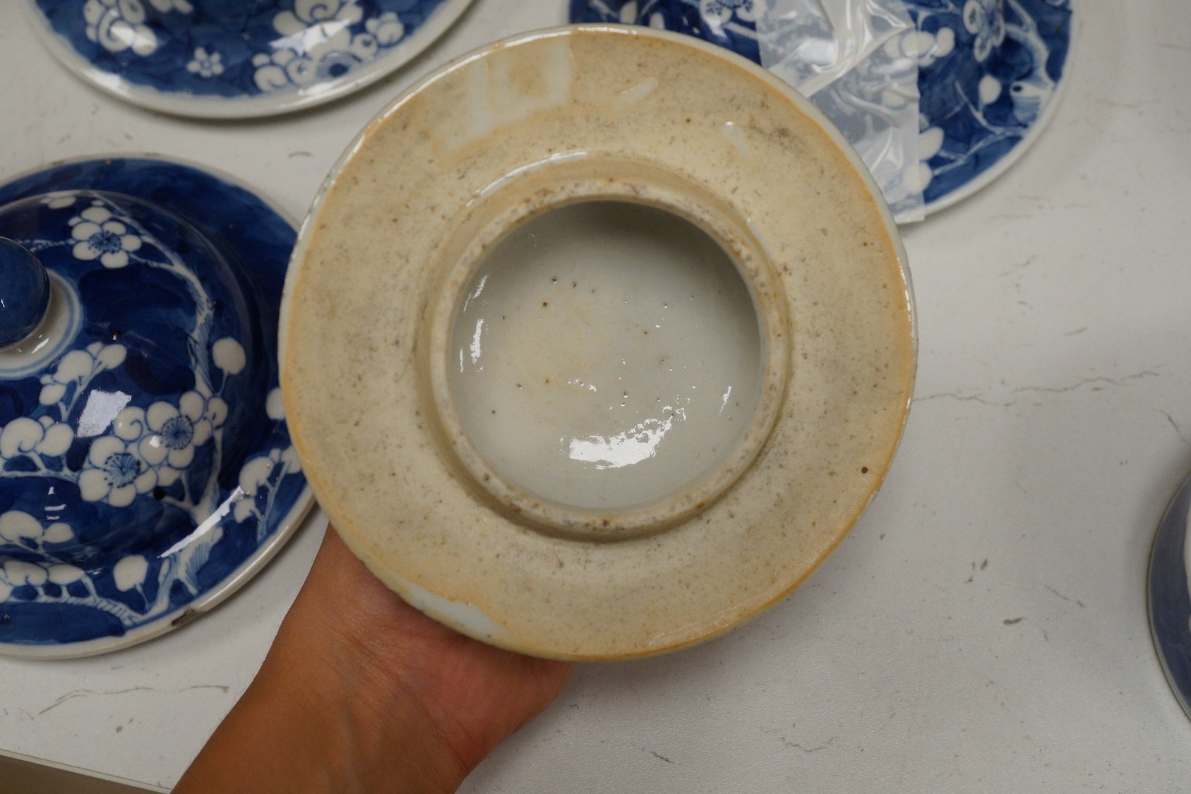 Twelve 18th/19th century Chinese blue and white ‘prunus’ vase and jar covers, largest 17 cm diameter, Provenance - D.C.Monk & Son, former dealers based in Kensington Church Street, London W8